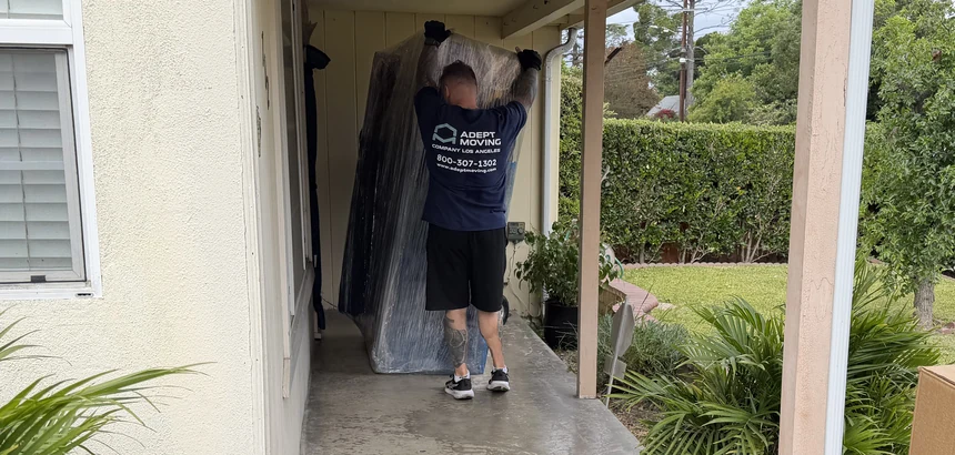 Adept Moving mover carrying wrapped furniture walkway in Arcadia