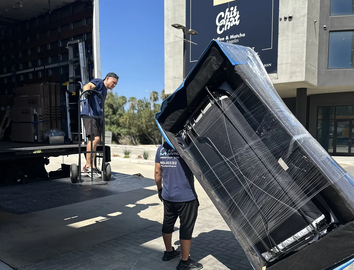 Adept Moving movers rolling stretch-wrapped furniture to the truck on Larian Way in Chatsworth, 91311