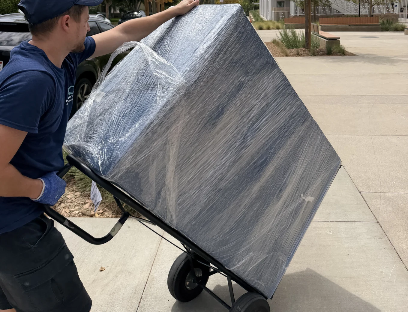 Adept Moving mover wheeling a wrapped piece on a hand truck on North Kenilworth Avenue in Glendale, 91202