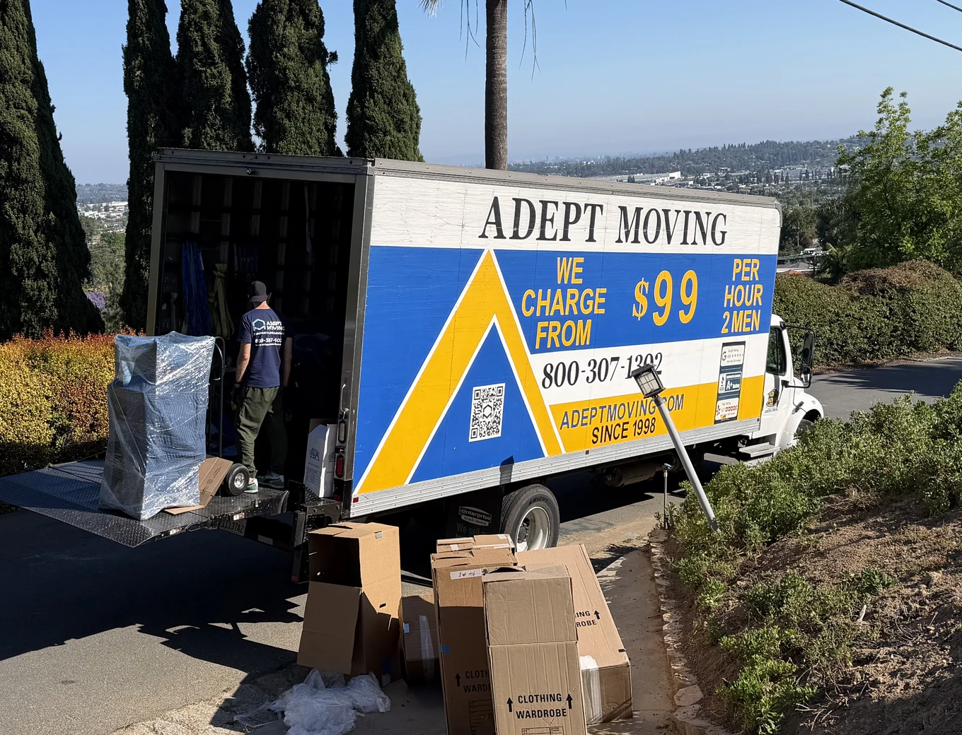 Adept Moving $99 branded truck on a hillside driveway with boxes staged on Mayapan Road in La Habra Heights, 90631