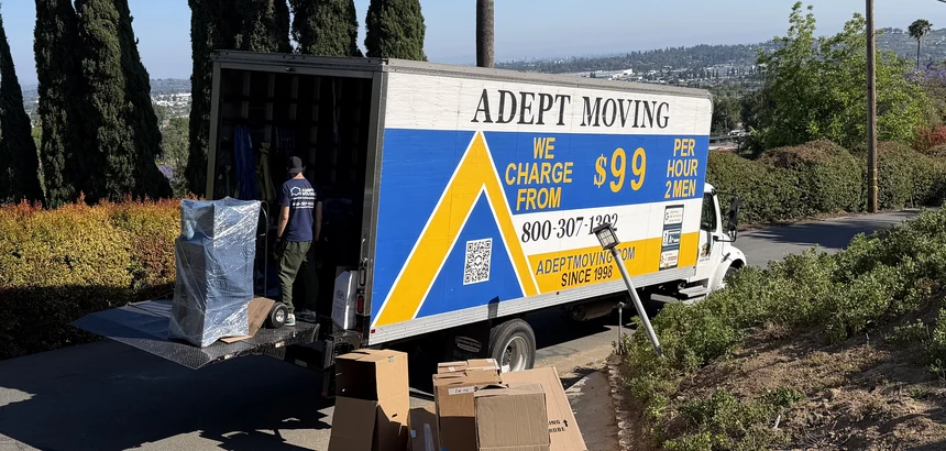 Adept Moving $99 branded truck on a hillside driveway with boxes staged on Mayapan Road in La Habra Heights, 90631