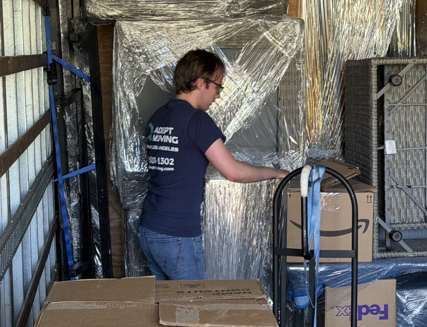 Adept mover inside a loaded moving truck with wrapped furniture and cartons on Mayapan Road in La Habra Heights, 90631