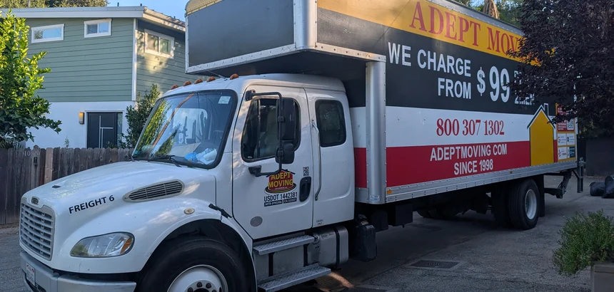Adept Moving branded box truck on a residential street in Los Angeles, 90042