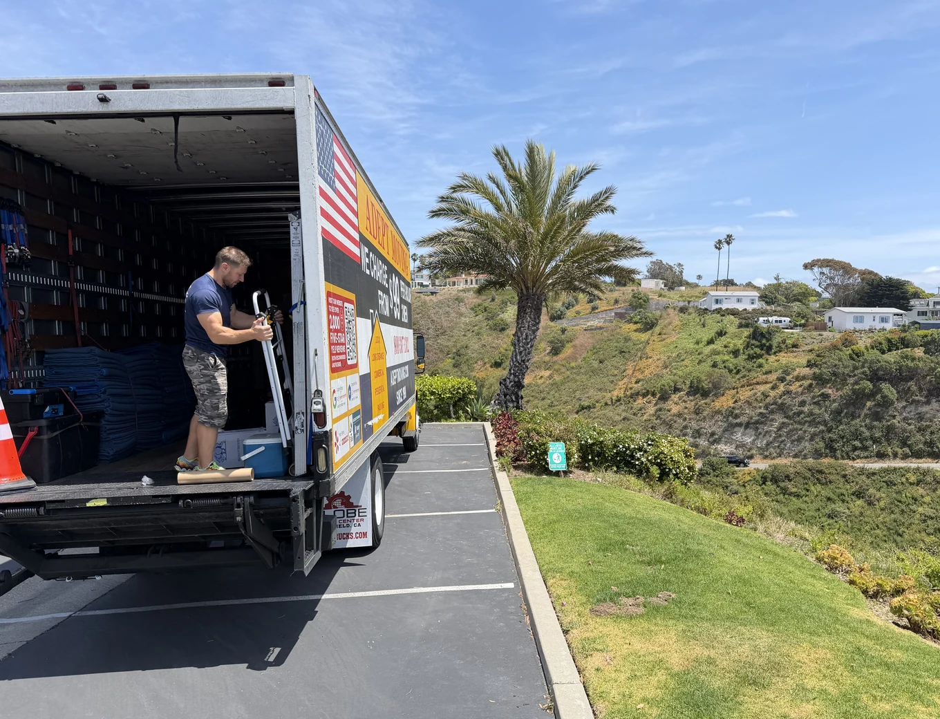 Adept mover with a dolly at the truck liftgate on Los Olas Way in Malibu, 90265