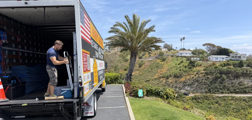 Adept mover with a dolly at the truck liftgate on Los Olas Way in Malibu, 90265