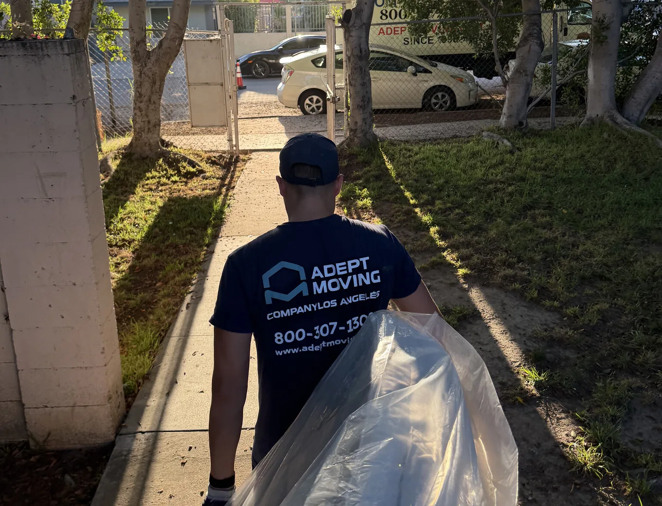 Adept Moving mover carrying a wrapped mattress on Willowcrest Avenue in North Hollywood, 91601