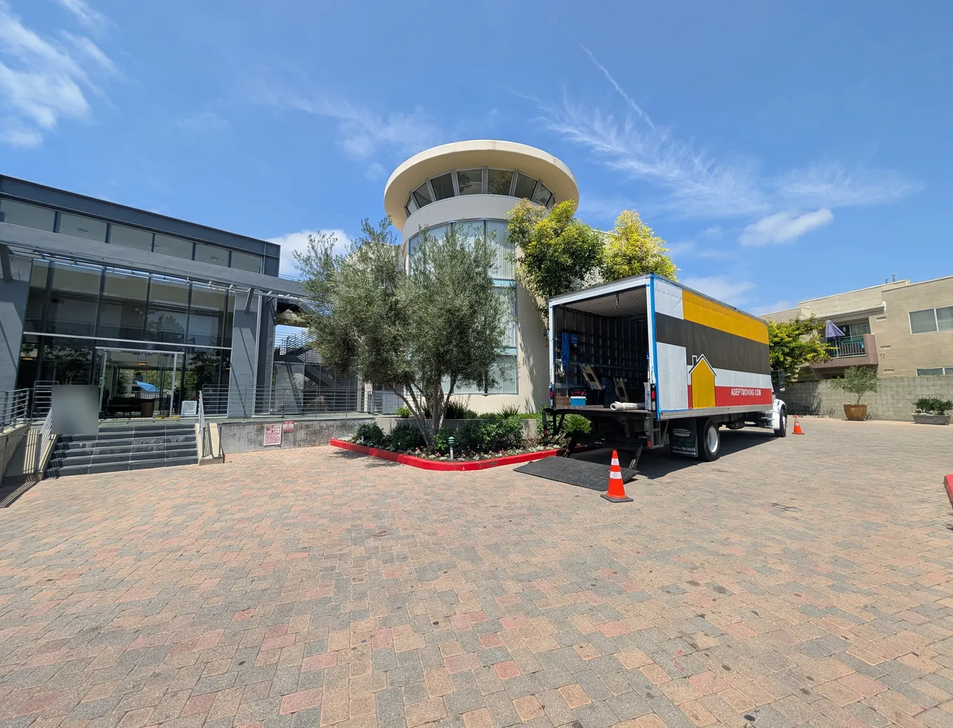 Adept Moving truck in the brick-paved entry court of an apartment complex off Reseda Boulevard in Northridge, 91324