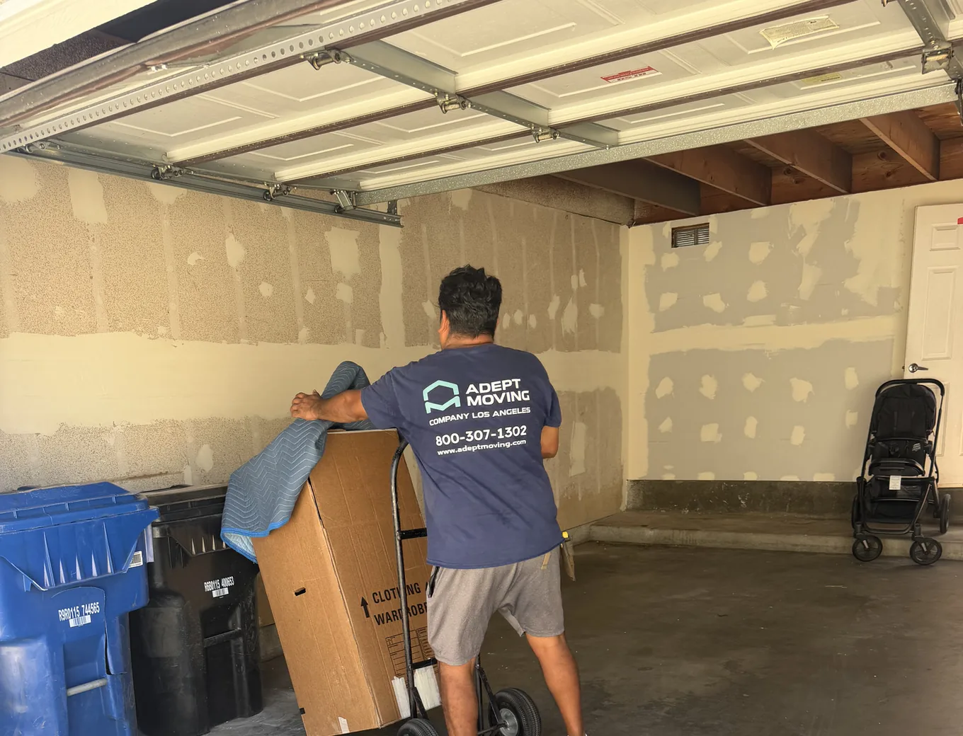 Adept Moving mover wheeling a wrapped piece out of a private garage off Devonshire Street in Northridge, 91325
