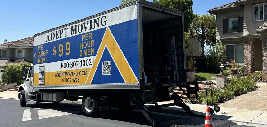 Adept Moving $99 branded box truck, side view with the liftgate down, on East Hollyoak Ridge in Orange, 92867