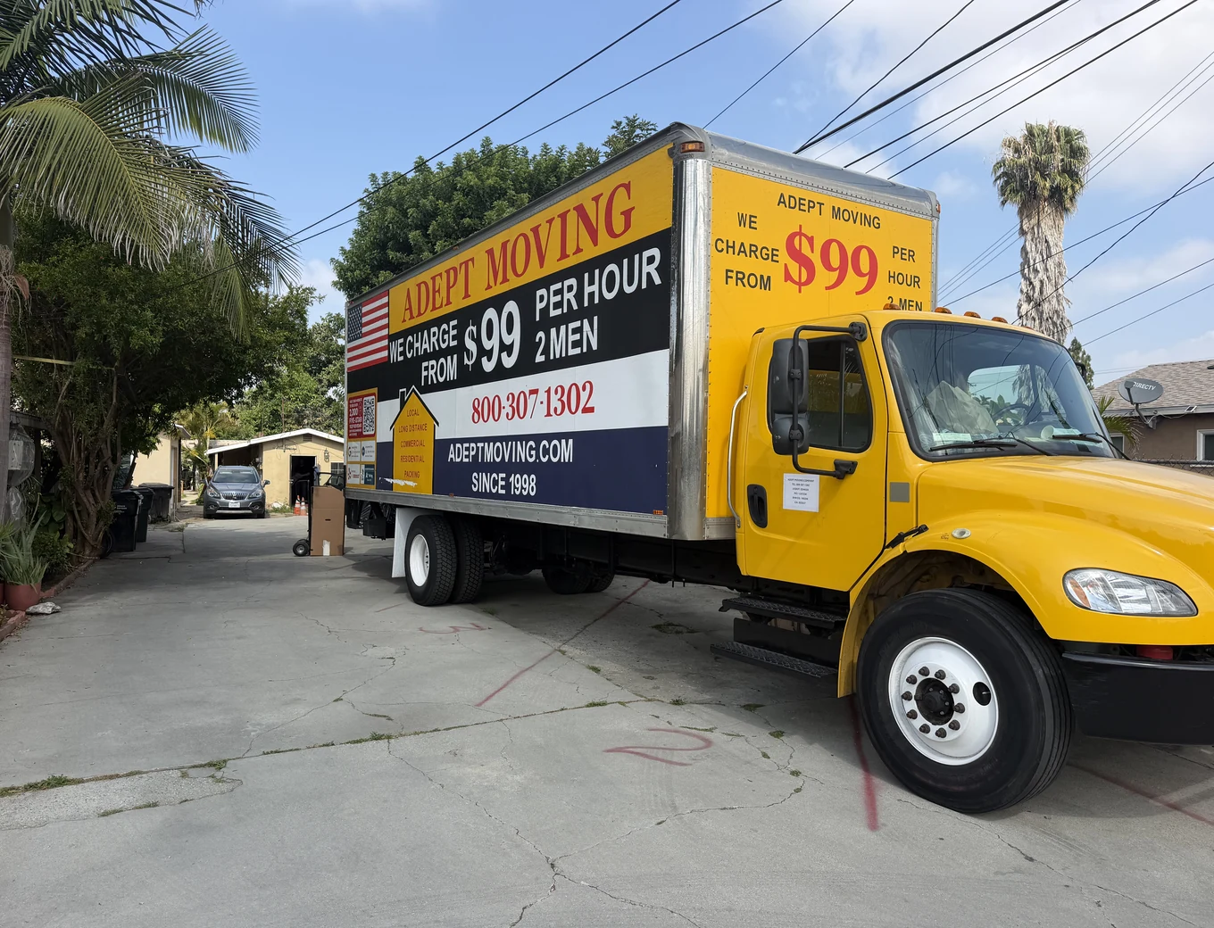 Adept Moving $99 yellow branded box truck, side view, on Gundry Avenue in Paramount, 90723
