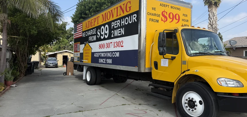 Adept Moving $99 yellow branded box truck, side view, on Gundry Avenue in Paramount, 90723