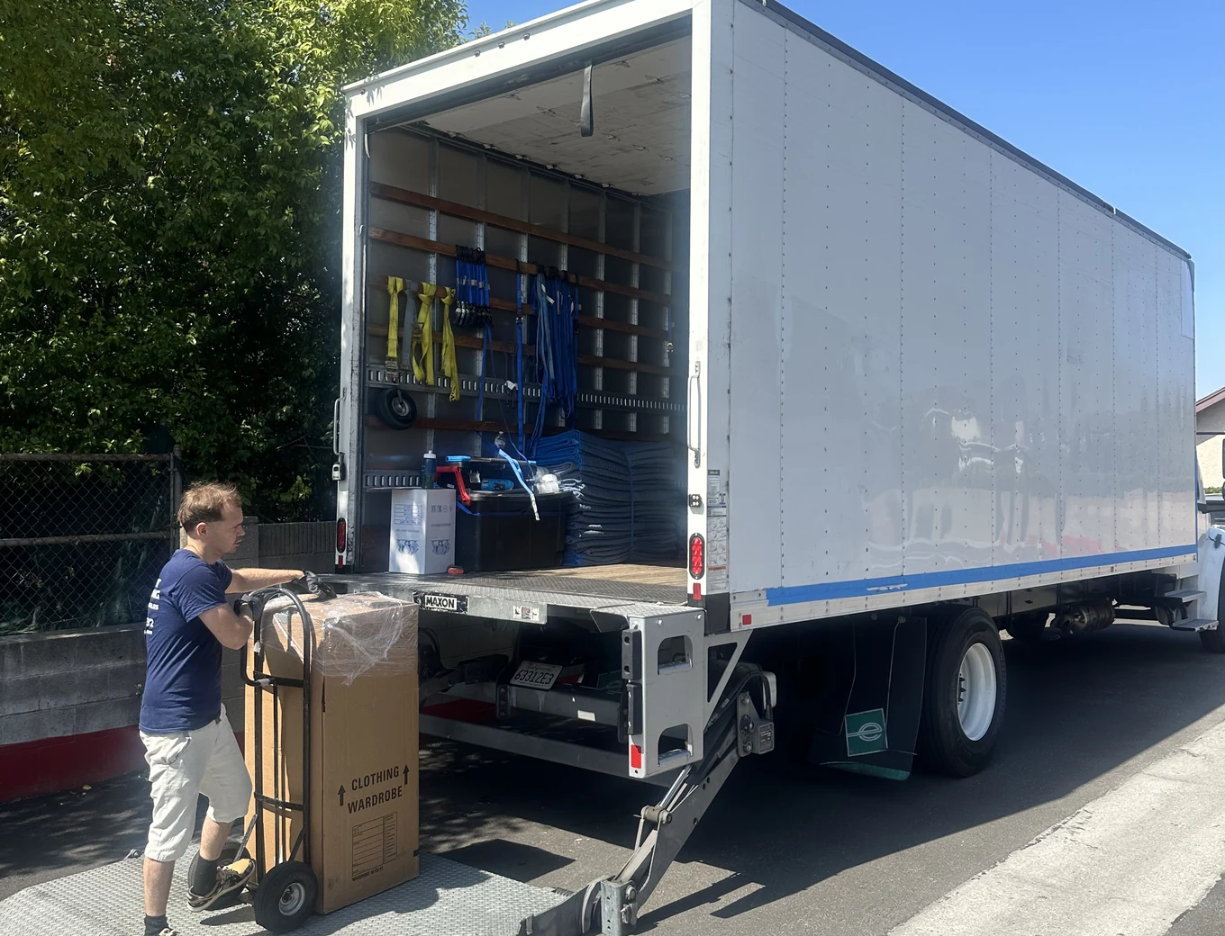 Adept mover loading packed boxes on a dolly in San Dimas, 91773