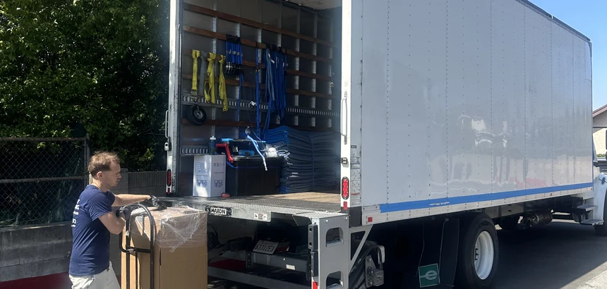 Adept mover loading packed boxes on a dolly in San Dimas, 91773