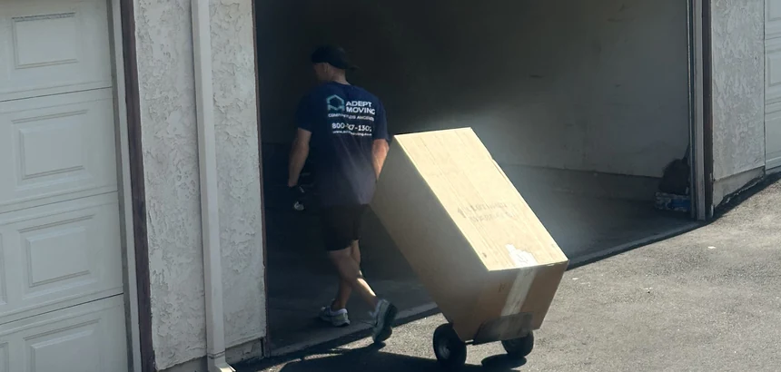 Adept mover moving a blanket-wrapped furniture piece on a hand truck in San Dimas, 91773