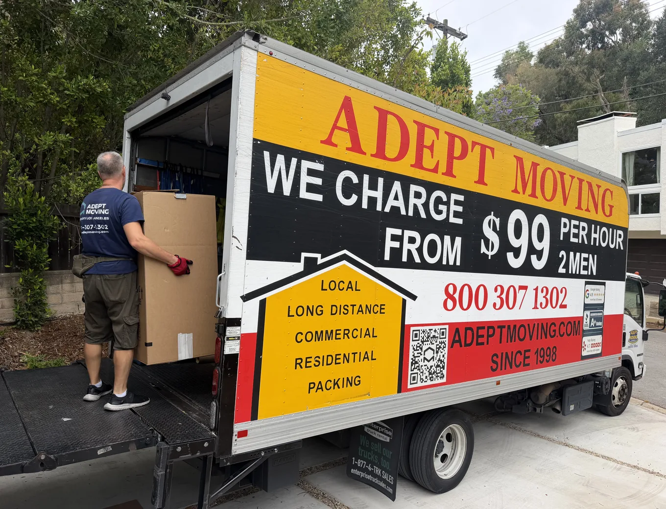Adept Moving mover carrying a box to the truck on Glorietta Drive in Sherman Oaks, 91403