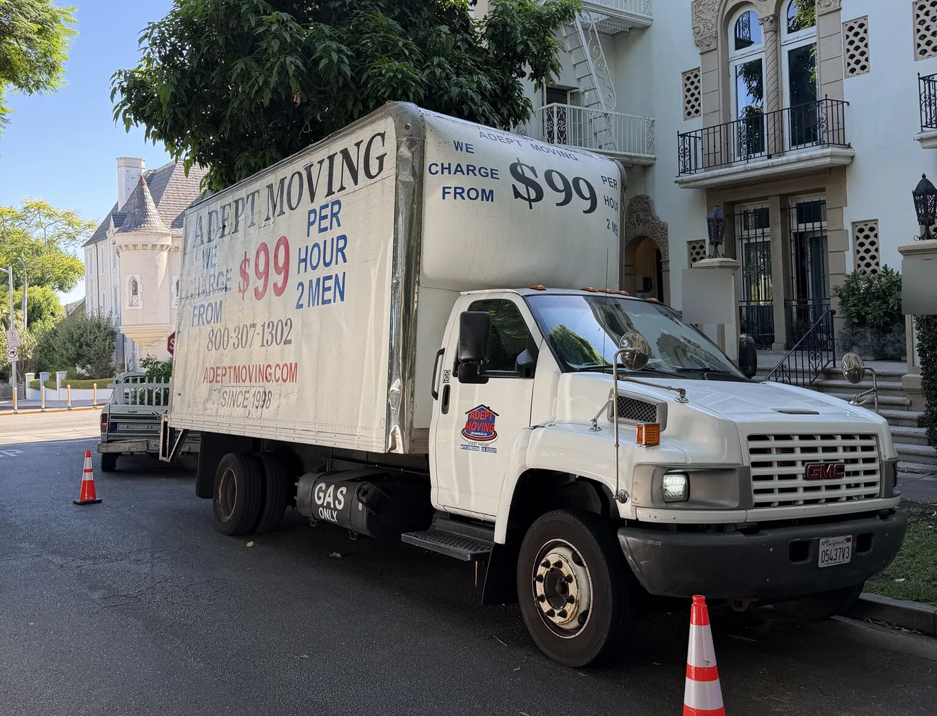 Adept Moving truck at the curb by a Spanish courtyard building on North Harper Avenue in West Hollywood