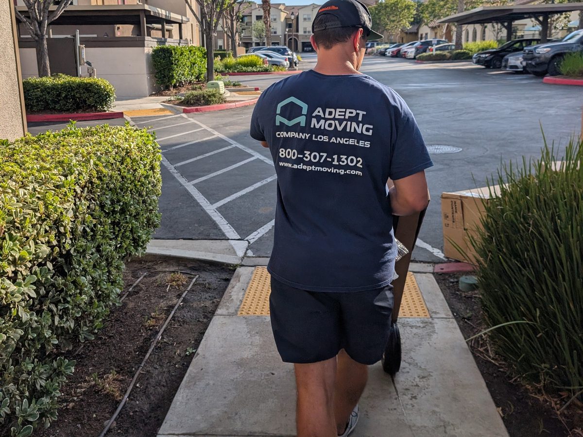 Adept Moving mover walking the apartment complex path back to the truck in Valencia, Santa Clarita