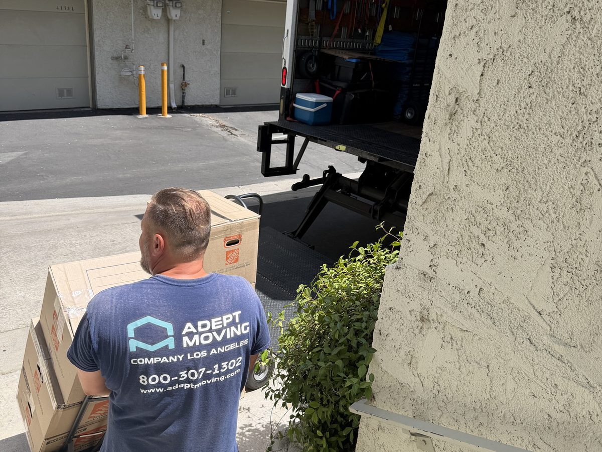 Adept Moving mover carrying a flat carton out to the truck at a Studio City complex