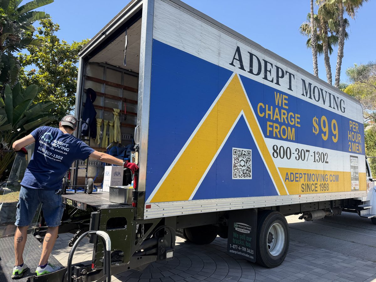Adept Moving mover loading a box off the liftgate of the truck on Cliffwood Avenue in Brea