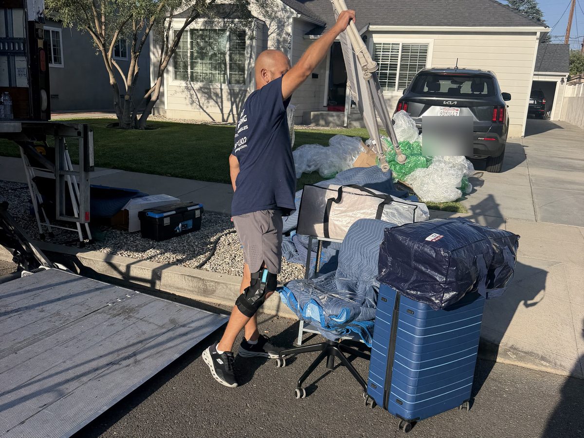 Adept Moving mover loading wrapped belongings at the truck liftgate in Burbank