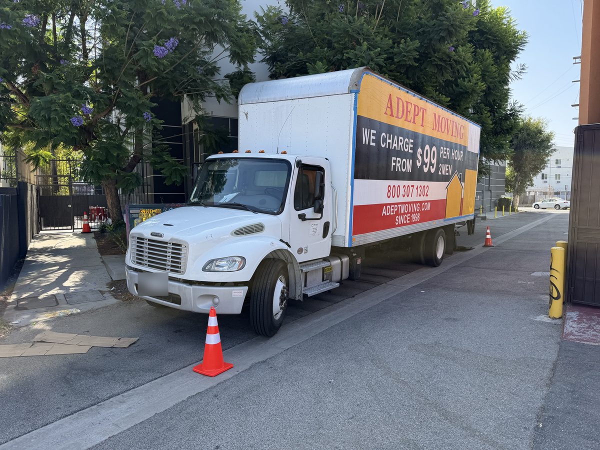 Adept Moving truck parked in the alley behind the apartment building on Lankershim Boulevard