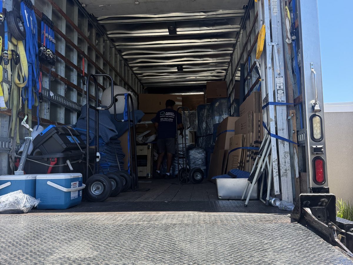 Inside the Adept Moving truck with straps and dollies along the walls